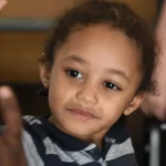 a young boy giving a high five