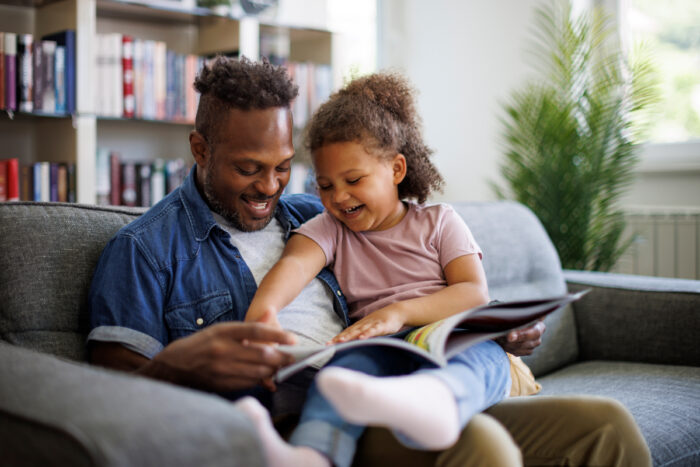 Father and daughter reading together