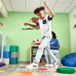 boy playing with colorful mats