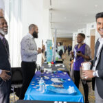 team members smiling at a conference